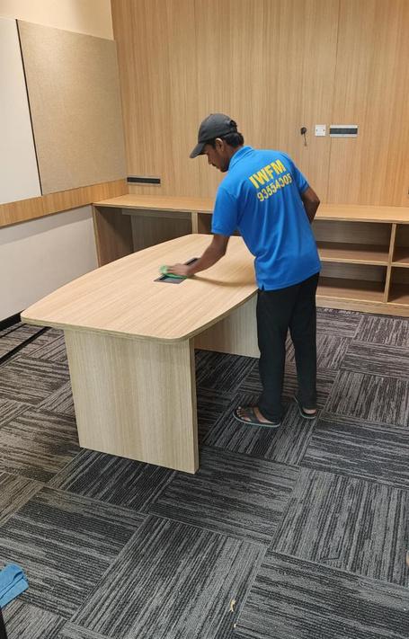 IWFM staff wiping down an office table
